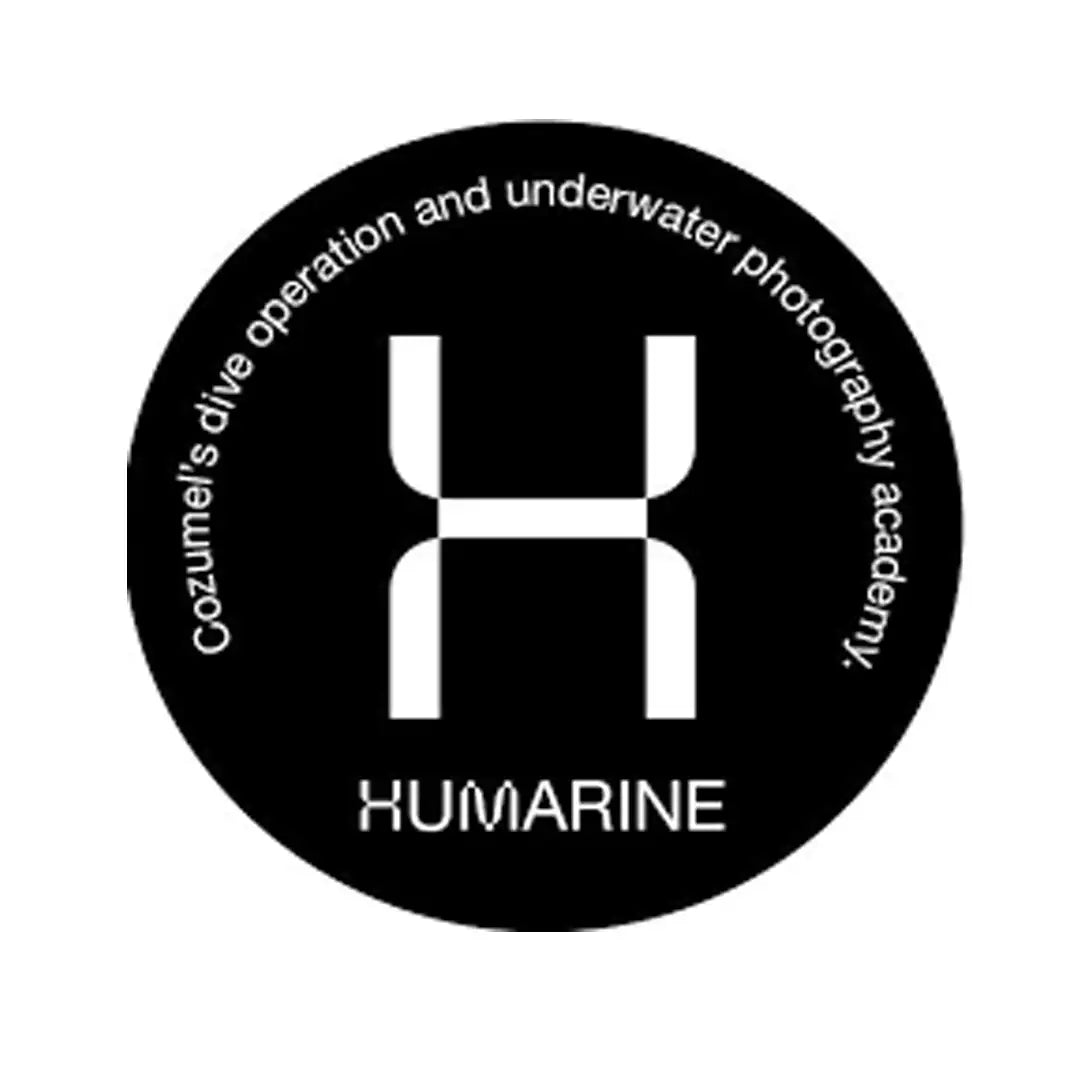 Black circular logo featuring a stylized white ’h’ and the text ’cozumel’s dive operation and underwater photography academy.’ with ’xumarine’ below.