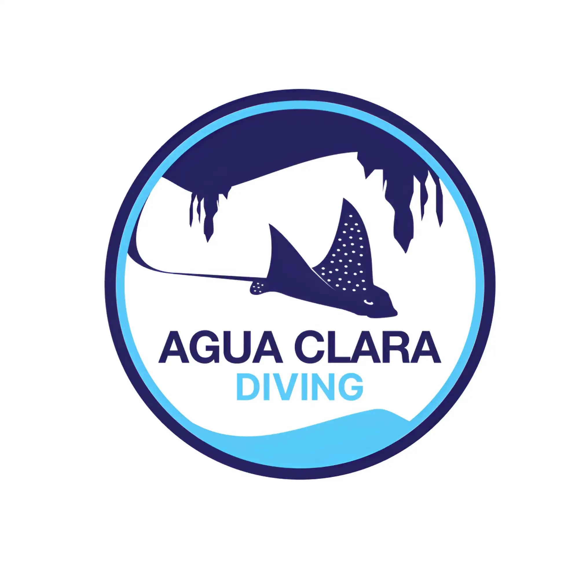 Circular logo for agua clara diving featuring a dark blue stingray with white spots swimming beneath an overhanging cave ceiling, framed by concentric circles in shades of blue.